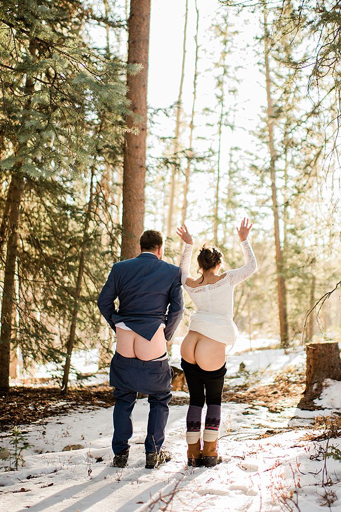 wedding couple mooning the camera in the forest of the Rocky Mountains during elopement day