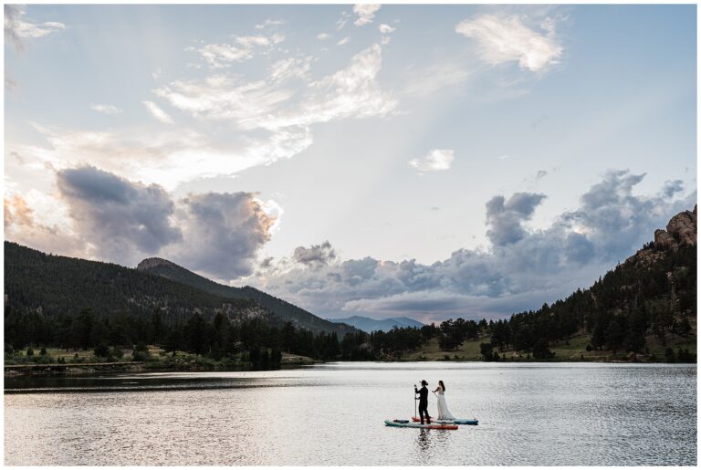 wedding couple paddleboarding on Lilly Lake at sunset in the mountains during paddleboard elopement in Colorado