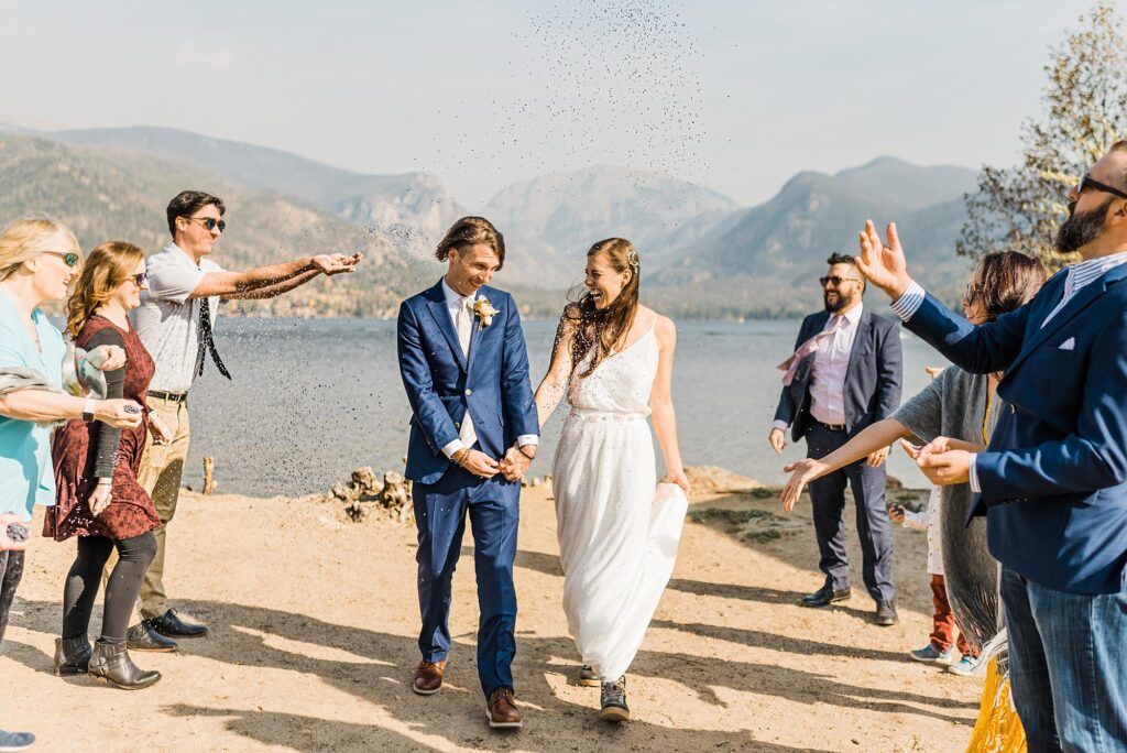 lavender toss with bride and groom after small wedding in grand lake colorado||||||||||||||||bride and groom reading vows during small wedding in grand lake colorado||||||bride tucking hair behind groom's ear during small wedding ceremony in grand lake colorado||||bride and groom celebrating after their small wedding ceremony in grand lake colorado|||bride and groom kissing during lavender toss after small wedding in grand lake colorado|bride and groom photos in rocky mountain national park|bride and groom kissing during wedding photos in rocky mountain national park|||||bride and groom popping champagne during small wedding in rocky mountain national park||bride and groom walking on trail ridge road during small wedding in rocky mountain national park|||||||