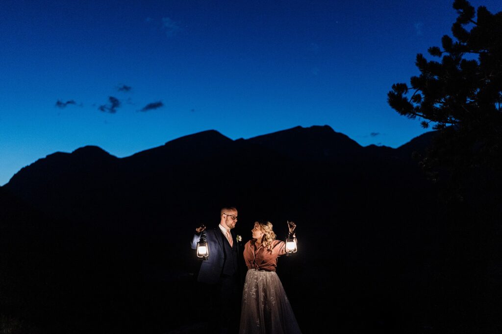 blue hour lantern photo of eloping couple with mountains in the background in Horseshoe Park